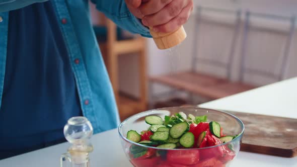 Pouring Salt Over Healthy Salad