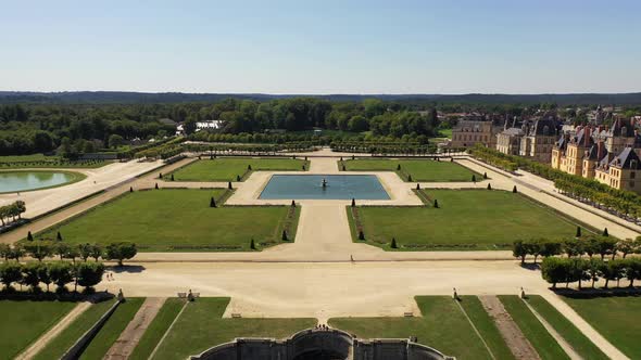Aerial View of Medieval Landmark Royal Hunting Castle Fontainbleau and Lake with White Swans, France