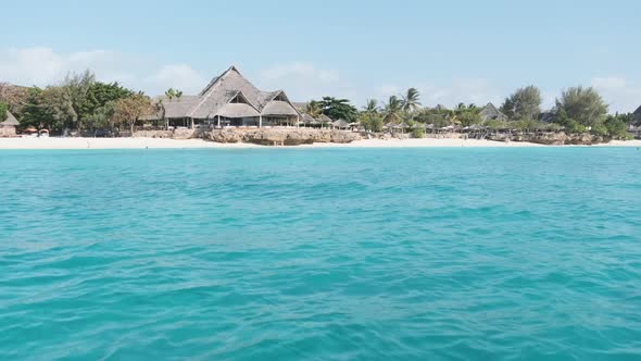 View From Boat to the Coast of Zanzibar with Paradise Beach Palms and Hotels