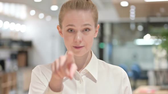Portrait of Happy Young Businesswoman with Pointing with Finger