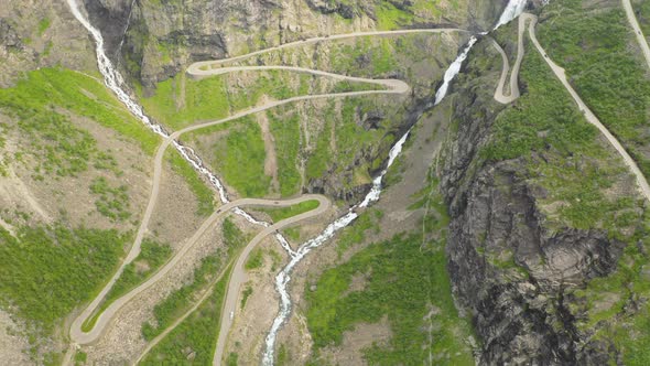 Top View Of The Winding Road Of Trollstigen And The High Cascade Of Stigfossen In Norway. aerial