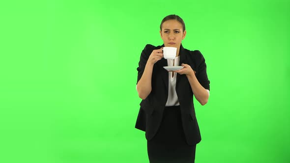 Girl Drinks Unpalatable Coffee and Is Disgusted. Green Screen