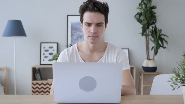 Upset Creative Man In Frustration for Results of Work on Laptop