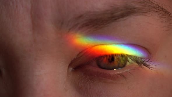 Glare of the rainbow on the female eye.