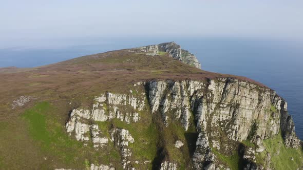 Aerial view of the mountains at Horn Head as the camera tilts down slowly