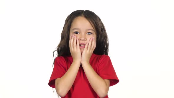 Girl Posing Surprisingly on White Background. Slow Motion