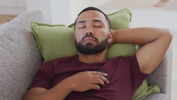 Man sleeping on the couch at home