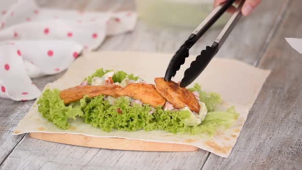 Woman Hands Cooking Pita with Vegetables and Chicken