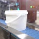 a white bucket with the finished product moves along the conveyor - VideoHive Item for Sale