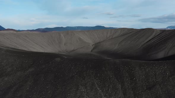 Drone Rising over Large Black Crater of Iceland Volcano