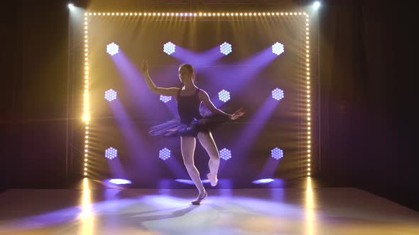 Young Flexible Ballerina in Black Tutu and Pointe Ballet Shoes. Graceful Dancing of Elements