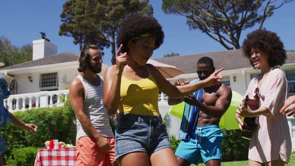 Diverse group of friends having fun and dancing at a pool party