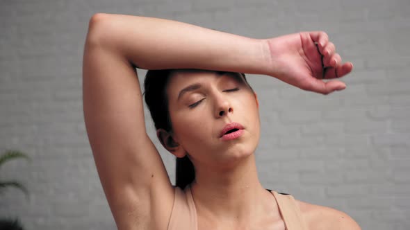 Sportive Strong Woman Wiping Sweat From Face After Intense Workout Exercise