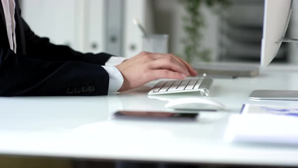 Hands of Businessman Typing on Wireless Keyboard