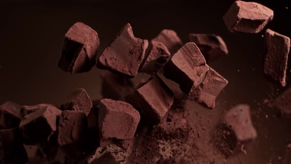 Super Slow Motion Shot of Raw Chocolate Chunks and Cocoa Powder After Being Exploded at 1000Fps