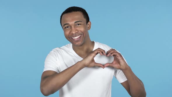 Handmade Heart By Young African Man Blue Background