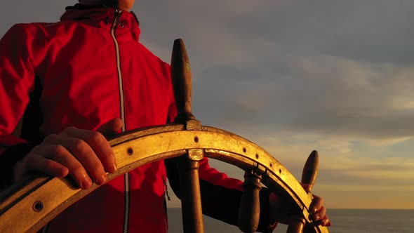 Captain holding ship rudder.