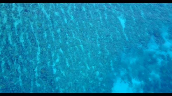 Aerial seascape of tropical shore beach break by blue ocean and clean sand background of a dayout ne