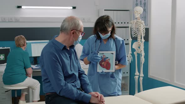 Female Assistant Holding Tablet with Cardiovascular System