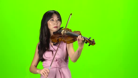Woman of Asian Appearance Playing the Violin