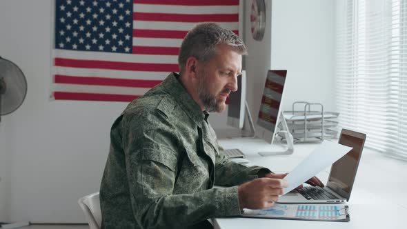 Army Officer Working with Documents