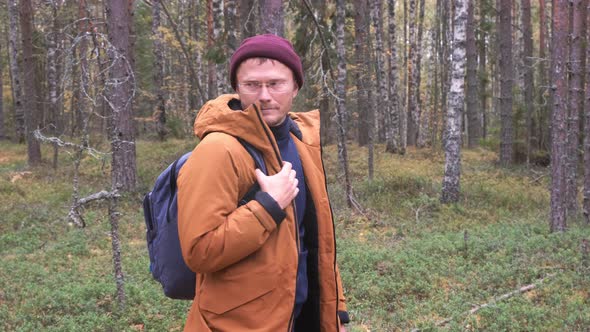 A Man Looking Around in the Forest to Understand His Location