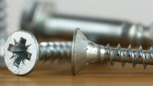 4K video slider screws and nails for renovation work. A close-up of a metal screw.