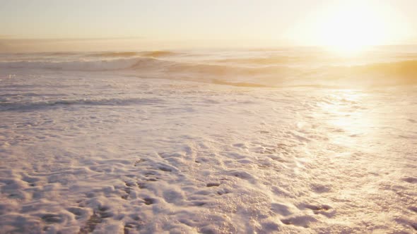 Sunset and sea with waves and blue sky on empty sunny beach