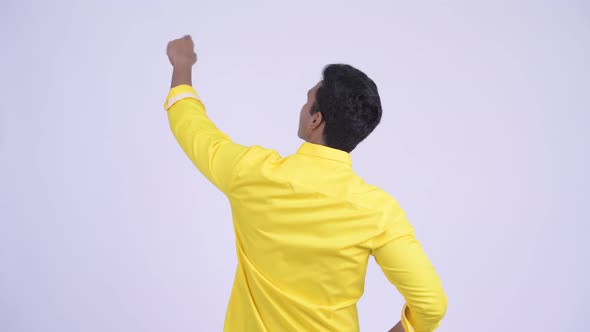 Rear View of Young Indian Businessman Pointing Finger