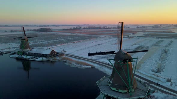 Wooden Wind Mill at the Zaanse Schans Windmill Village During Winter with Snowy Landscape Snow