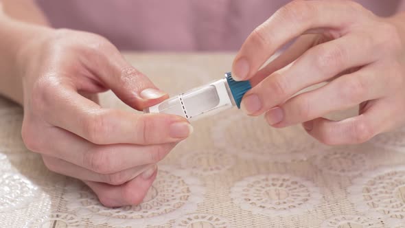 a Woman Open a Tube to Collect Saliva for a DNA Test