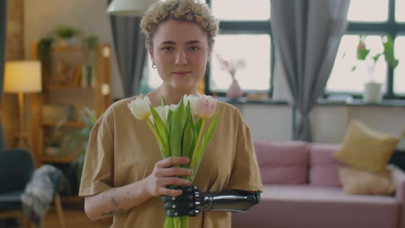 Portrait of Pretty Girl with Prosthetic Arm Holding Flower Bouquet