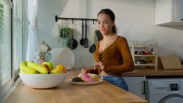 Beautiful Latino woman reject donut and enjoying eat healthy food.