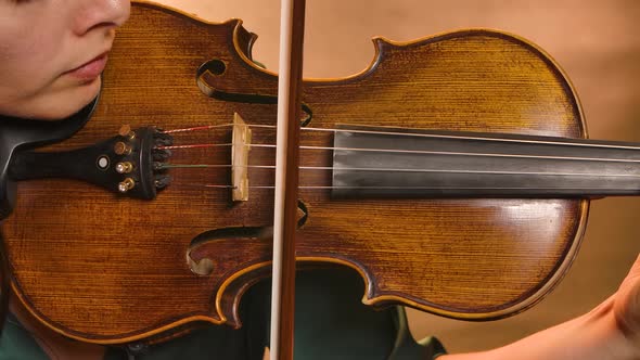 Professional Violin Playing. Close-up Instrument in the Hands of a Young Woman Musician. Slow Motion