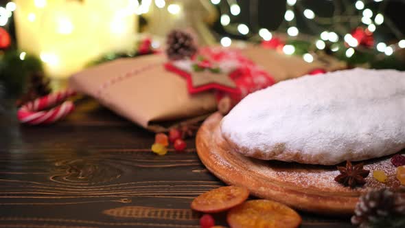 Traditional Christmas Stollen Cake and New Year Decorations on Wooden Background