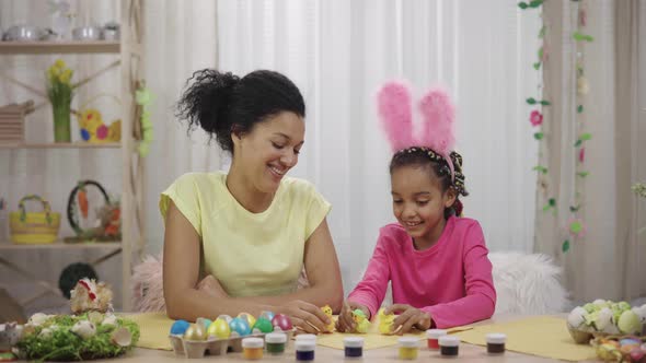 Mom and Daughter with Funny Bunny Ears Have Fun with Decorative Chicks