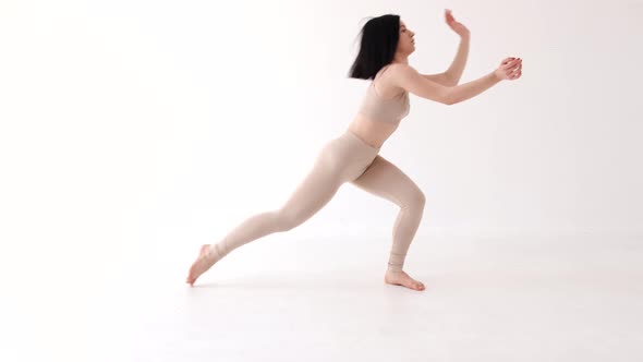 Woman in Beige Costume Dancing Contemp on White Background