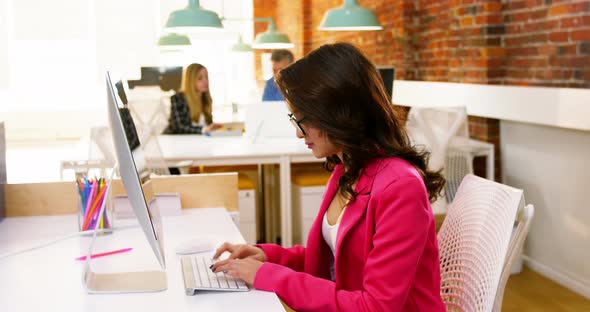 Female executive working on computer at desk