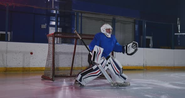 Professional Hockey Player Attacks the Gate and Strikes, but the Goalkeeper Beats the Puck. A Goal