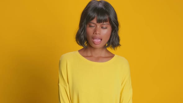Astonished Young Woman Looks Amazement Stares Disbelief Over Yellow Background