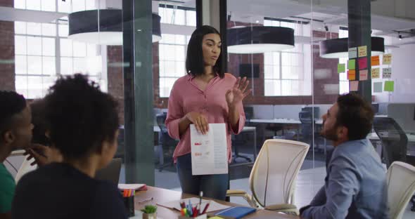 Mixed race businesswoman having a meeting with colleagues in meeting room