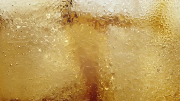 Cola With Ice And Bubbles Close Up