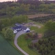 Aerial video slowing approaching farm with lots of green trees and plants - VideoHive Item for Sale