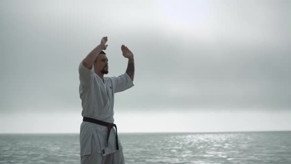 Taekwondo Man Training Strength Near Calm Sea