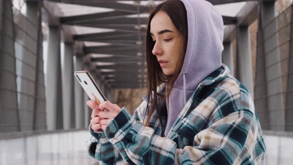 Closeup beautiful woman typing message on mobile phone. Young girl chatting on phone in slow motion.