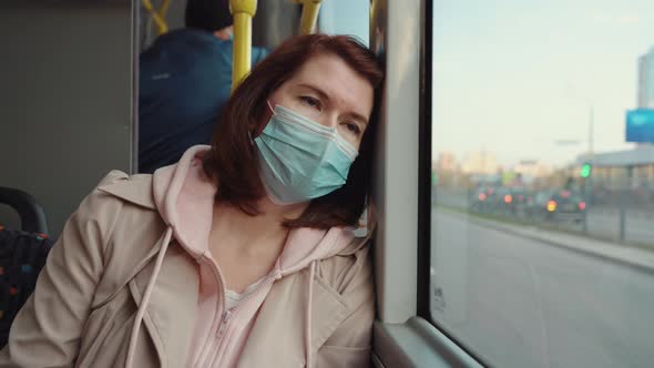 Tired Woman Leaning on Window in Bus
