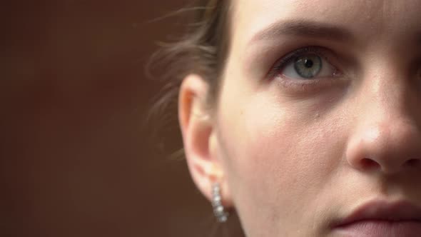 Half Face of a Beautiful Young Woman Looking at the Camera