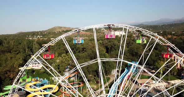 A City Park with Rides and a Ferris Wheel