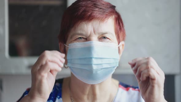 Senior Woman Taking Off Mask at End of Lockdown