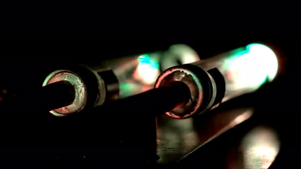 Two Glowing Flasks, One Blinking Red. It Looks Like a Device with Two Safety Power Blocks, One alt